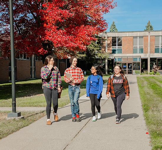 four students walking the madonna university livonia campus and interacting