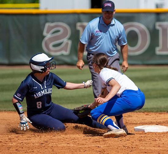 Madonna softball player tagging opponent as umpire makes call